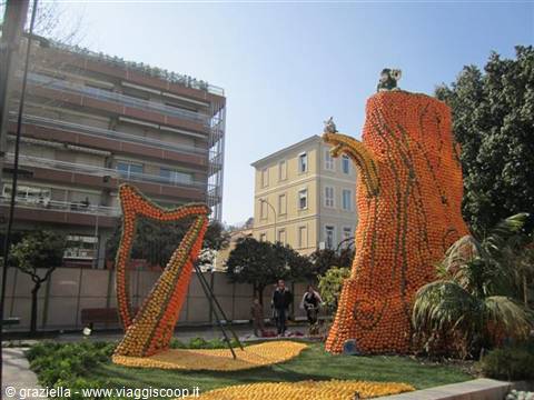 Orange sculptures shaped like a harp and teapot, citrus festival