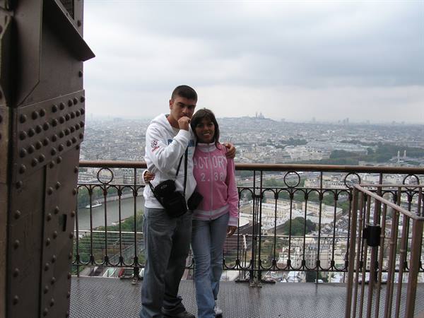 Couple of tourists standing on the iron deck of the Eiffel Tower, Paris