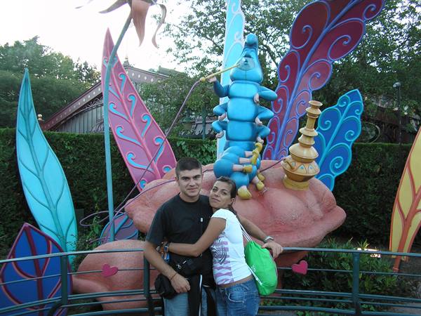 Couple hugging in front of the blue caterpillar at Disneyland Paris