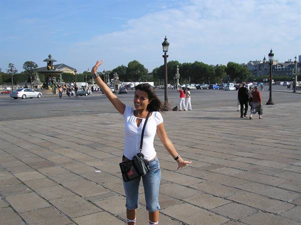 Woman waving with raised arm at Place de la Concorde, Paris