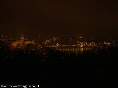 Dark night: the illuminated Chain Bridge reflects on the Danube, Budapest