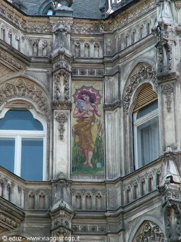 Neo-Gothic facade with Art Nouveau mosaic of a woman with umbrella