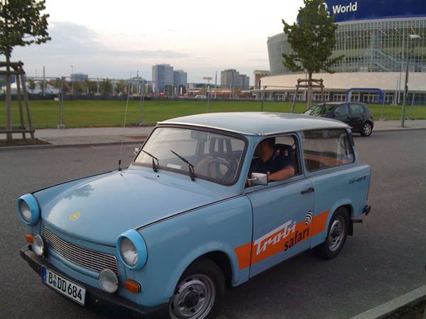 Light blue Trabant Trobi Safari with driver at the wheel near Berlin's O2 World
