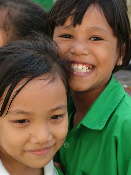 Smiling girls in green shirts, natural light