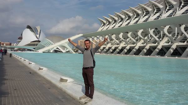 Man with raised arms beside the pool at the City of Arts and Sciences, Valencia