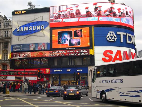 Piccadilly Circus: glowing Samsung and TDK billboards above crowds and buses