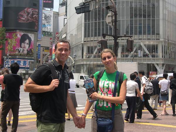 Tourist couple holding hands at Shibuya crossing, Tokyo