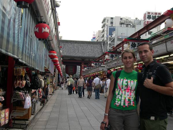 Tourists on Nakamise shopping street in Asakusa, red lanterns leading to Senso-ji temple