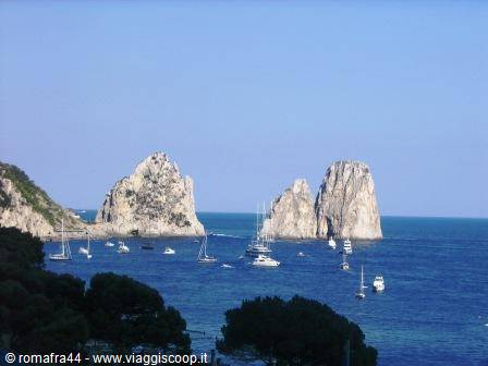 The Faraglioni rocks of Capri rise from the blue sea among sailboats and pines