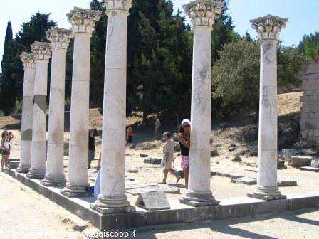 Corinthian marble columns at ancient Cos agora, tourists among the ruins