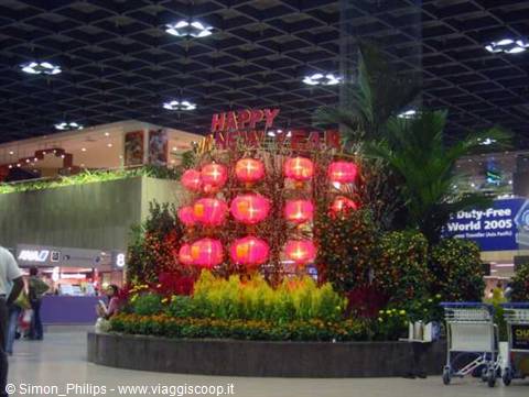 Red lanterns and palms celebrating New Year inside Changi Airport