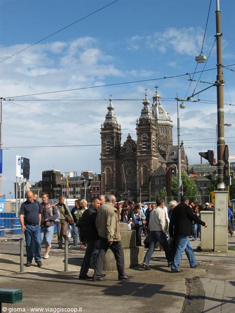 Pedestrians crossing the square in front of Saint Nicholas Basilica, Amsterdam