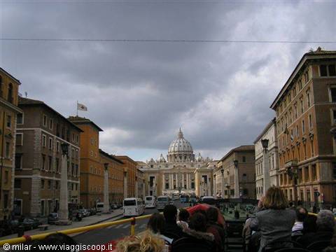 Tourists on an open-top bus along Via della Conciliazione toward St. Peter's dome