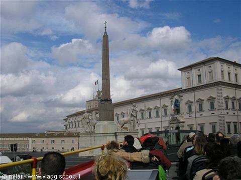 Tourists on an open bus in front of the Quirinale obelisk in Rome