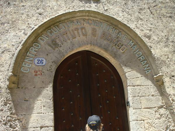 Wooden door beneath the stone arch of the Ettore Majorana Scientific Culture Centre
