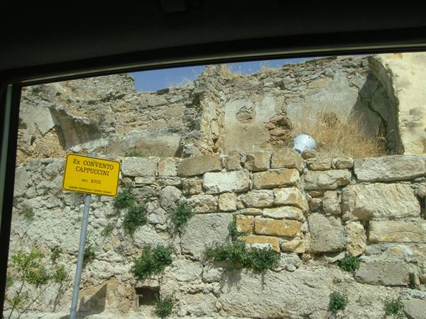 Yellow Ex Convento Cappuccini sign in front of crumbling stone walls