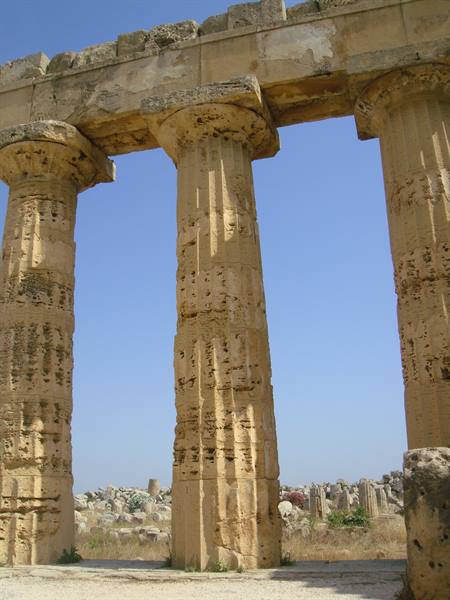 Weathered Doric stone columns of Selinunte acropolis against clear blue sky