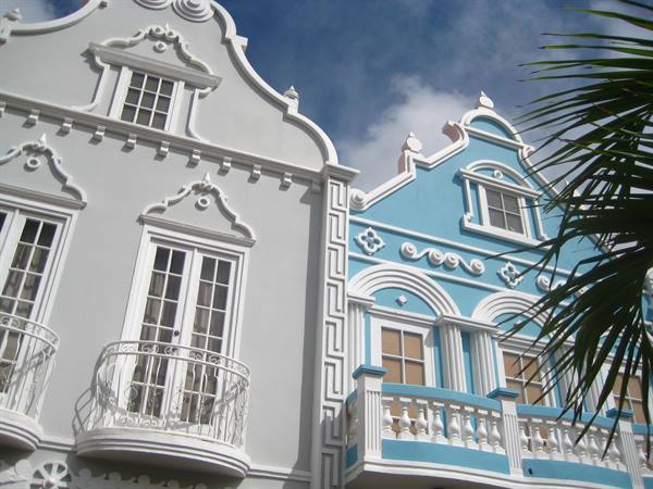 White and blue colonial facades with wrought iron balconies in Oranjestad, Aruba