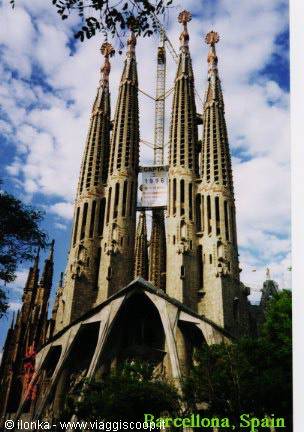 Sagrada Familia towers in Barcelona under a partly cloudy sky