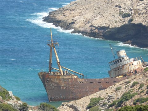 Rusty shipwreck stranded on the rocky coast of Amorgos