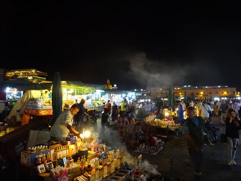 Lit food stalls and smoke at Jemaa el-Fna square in Marrakech at night