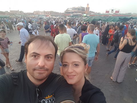Couple taking selfie among the crowds at Jemaa el-Fna, Marrakech