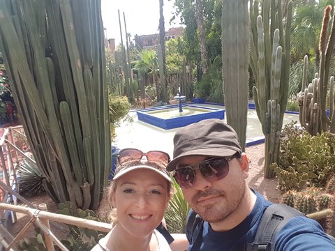 Couple selfie among cacti and blue fountain, Majorelle Garden, Marrakech