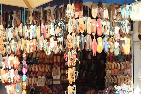 Colorful leather babouches hanging in a shoe shop in the Fes souk