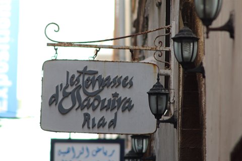 Sign of Les Terrasses d'Essaouira riad with black lanterns in Marrakech