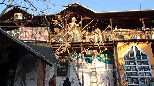 Metal skeleton sculptures on the facade of Metelkova art center in Ljubljana