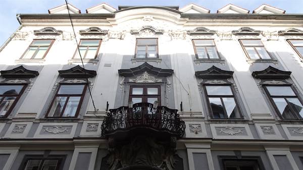 White Baroque facade with wrought iron balcony, light and shadow