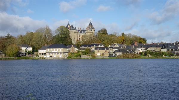 Combourg castle rises above slate-roofed houses by the lake