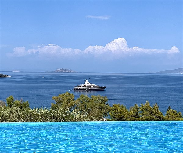 Infinity pool, endless sea and a boat dreaming of summer.