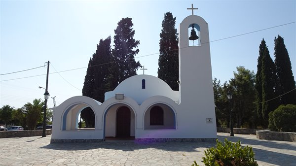 A little white church among the cypresses, the sun surprised us here.