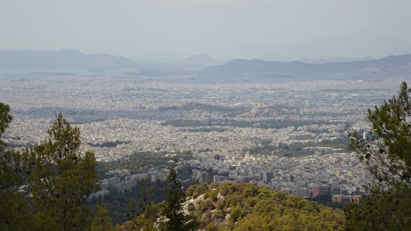 Athens stretches out calmly under the mist: a magical moment from the hill.