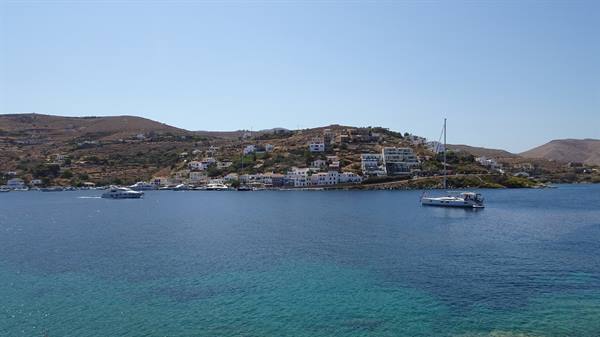 The emerald green sea welcomes the boat: here time stands still.