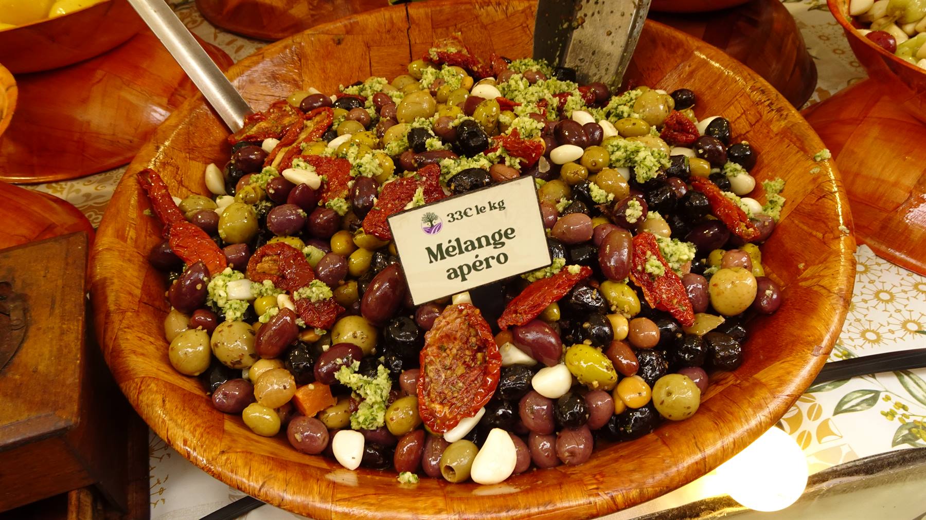 Ciotola di legno con olive miste e pomodori secchi, mercato di Yvoire