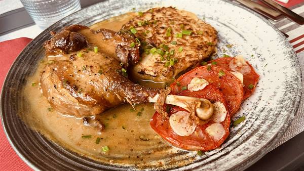 Duck confit with sauce, garlic tomatoes and galette, Normandy dish