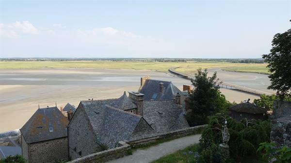 Slate rooftops of Mont Saint Michel above the tidal flats and causeway