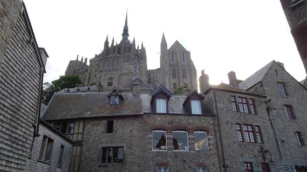 Mont Saint Michel abbey rising above the village stone houses
