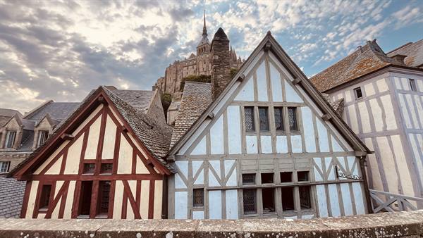 Half-timbered houses at Mont Saint Michel with abbey on the rock