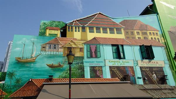 Mural on building facade depicting traditional houses, sailboats and Kampong Gelam signs