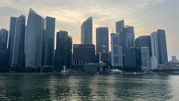 Singapore skyscrapers at sunset, the sky turns to gold.