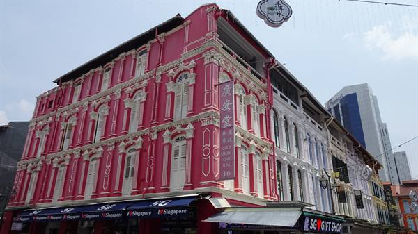 Gift shop beneath pink and white colonial shophouse in Singapore's Chinatown