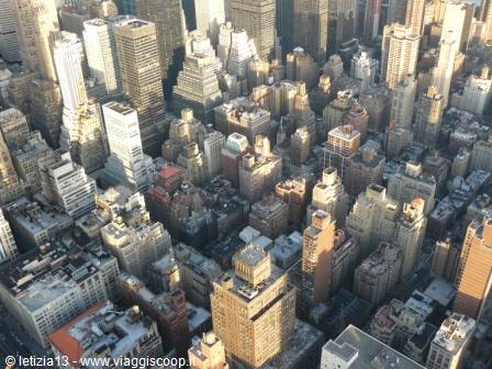 Manhattan skyscrapers seen from above, golden light over New York rooftops