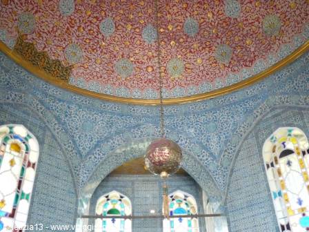 Dome with blue Iznik tiles, brass lamp and stained glass windows
