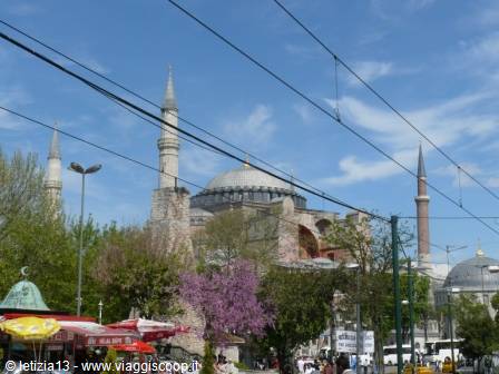 Hagia Sophia in Istanbul, dome and minarets behind tram cables, blue sky