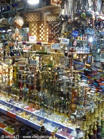 Bazaar stall with brass hookahs and hanging lanterns under artificial light