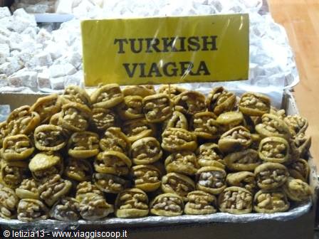 Tray of walnut pastries at the bazaar, with a yellow handwritten sign