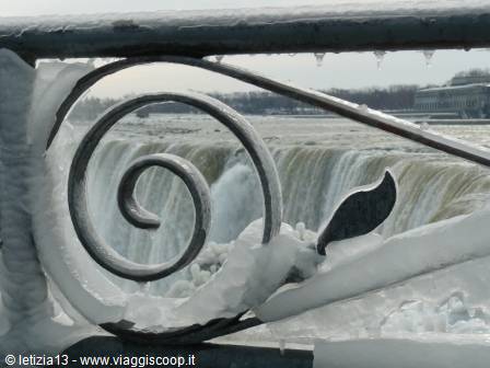 Iron railing covered in ice in front of Horseshoe Falls